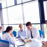 Group of happy young  business people in a meeting at office